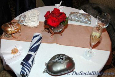 reception table for charity ball with pretty purses strewn about